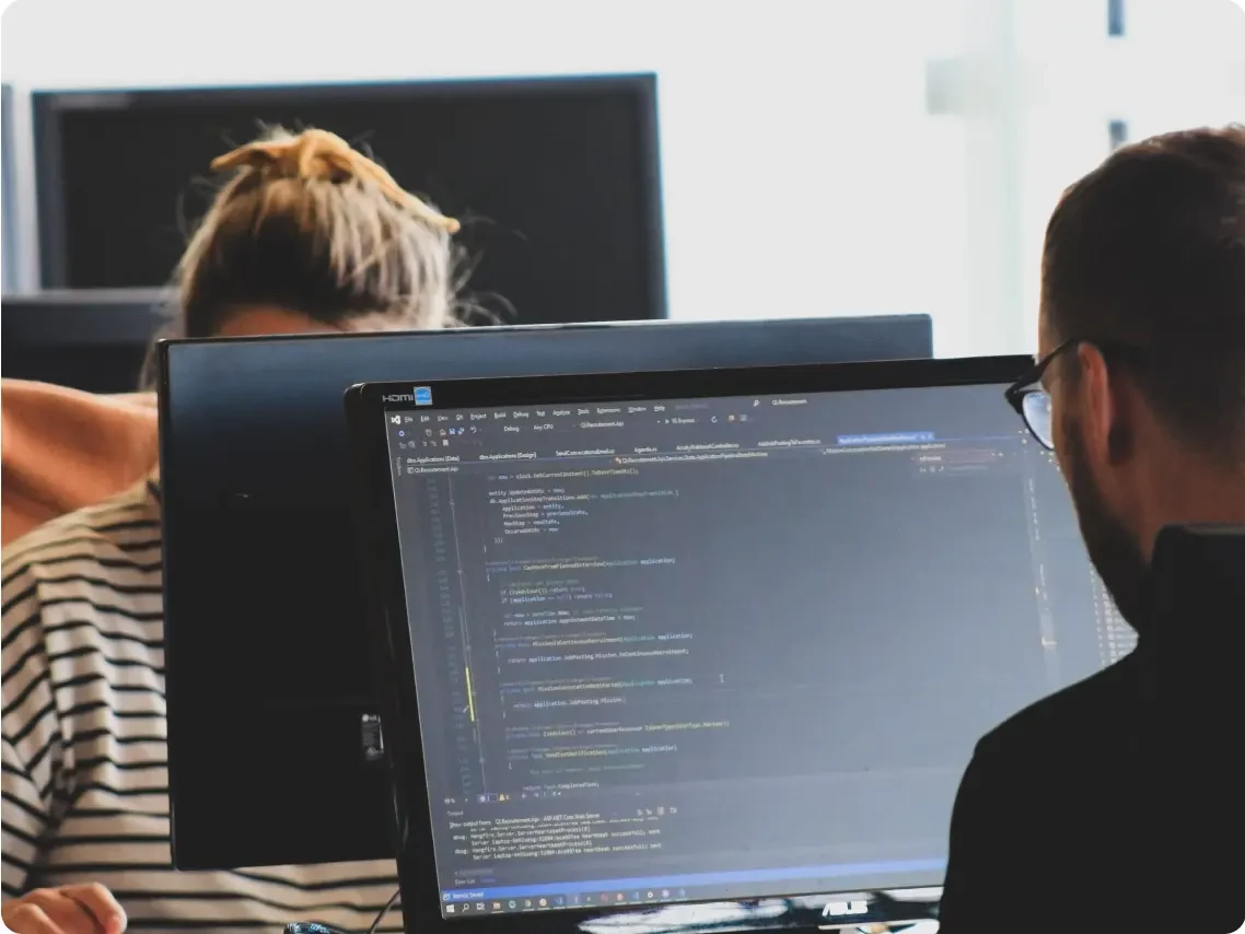 Woman and man using computers.